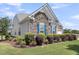 Well-maintained home featuring stone detail, lush landscaping and vibrant blue shutters at 522 Tidewater Chase Ln, Summerville, SC 29486