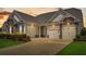 Inviting exterior with stone accents, three-car garage, and well-manicured landscaping at 522 Tidewater Chase Ln, Summerville, SC 29486