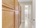 Hallway with large, wooden cabinets and neutral tile floors, offering ample storage space at 522 Tidewater Chase Ln, Summerville, SC 29486