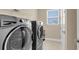 Laundry room features modern appliances and a window, making laundry chores more pleasant at 522 Tidewater Chase Ln, Summerville, SC 29486