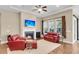 Inviting living room features a cozy fireplace, ceiling fan, and comfortable seating, perfect for relaxation at 522 Tidewater Chase Ln, Summerville, SC 29486