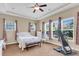 Bright main bedroom with comfortable carpet, tray ceiling, windows, and ceiling fan at 522 Tidewater Chase Ln, Summerville, SC 29486
