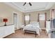 Spacious main bedroom with tray ceiling, fan, and ample natural light from multiple windows at 522 Tidewater Chase Ln, Summerville, SC 29486