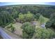Expansive property featuring a pool, outbuildings and a sprawling lawn surrounded by lush trees at 5615 Highway 165, Ravenel, SC 29470
