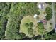 A private home with a pool and outbuildings nestled amidst a forest of lush trees at 5615 Highway 165, Ravenel, SC 29470