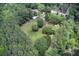 A well-kept home with an outbuilding surrounded by lush trees and a large lawn at 5615 Highway 165, Ravenel, SC 29470