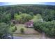 Aerial view of the property showing the home, outbuildings and surrounding greenery at 5615 Highway 165, Ravenel, SC 29470
