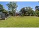 Spacious backyard featuring a pool, dog kennel, and mature trees at 5615 Highway 165, Ravenel, SC 29470