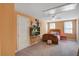 Bright bedroom with twin windows, ceiling fan, TV and comfortable bed with colourful pillows and sheets at 5615 Highway 165, Ravenel, SC 29470