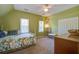 Bright bedroom features olive green walls, carpet and an inviting bed at 5615 Highway 165, Ravenel, SC 29470