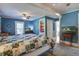Bedroom with wood floors, blue walls, and a TV on a wooden console at 5615 Highway 165, Ravenel, SC 29470