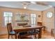 The dining room features a fireplace and wooden table with chairs and bench seating at 5615 Highway 165, Ravenel, SC 29470