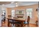 Dining room featuring a fireplace, wooden table, chairs, and a bench with leather padding at 5615 Highway 165, Ravenel, SC 29470