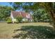 Charming home with a well-manicured lawn and mature trees offers classic curb appeal at 5615 Highway 165, Ravenel, SC 29470