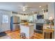 Bright kitchen features stainless steel appliances, island with granite countertops, and white cabinets at 5615 Highway 165, Ravenel, SC 29470