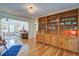 Comfortable living room with hardwood floors, built-in bookshelves, and seamless flow to other living spaces at 5615 Highway 165, Ravenel, SC 29470