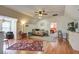 Spacious living room with hardwood floors, ceiling fan, stylish furniture and an open doorway to an adjacent room at 5615 Highway 165, Ravenel, SC 29470