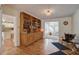 Cozy living room with hardwood floors, built-in bookshelves, and seamless flow to other living spaces at 5615 Highway 165, Ravenel, SC 29470