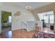 Loft area with hardwood floors, mini fridge, wall art, and a view into bedroom at 5615 Highway 165, Ravenel, SC 29470