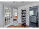 Bright mud room with hardwood floors, shoe rack, and double french doors to the outside porch at 5615 Highway 165, Ravenel, SC 29470
