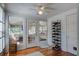 Mudroom with hardwood floors, windowed door to porch, ceiling fan and shoe rack at 5615 Highway 165, Ravenel, SC 29470