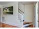 Staircase featuring wooden treads, white risers, and a mounted TV at 5615 Highway 165, Ravenel, SC 29470