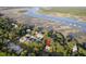 An aerial view of a quaint neighborhood nestled among lush greenery, showcasing waterfront access and stunning marsh views at 5655 Captain Kidd Rd, Hollywood, SC 29449