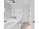 Bathroom with a double sink vanity, a large mirror, black hardware, and tiled flooring at 5655 Captain Kidd Rd, Hollywood, SC 29449