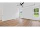 Spacious bedroom with natural light, ceiling fan, and hardwood floors creating a relaxing atmosphere at 5655 Captain Kidd Rd, Hollywood, SC 29449