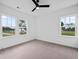 Bright bedroom with carpeted floors, fan, and windows at 5655 Captain Kidd Rd, Hollywood, SC 29449