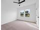 Bright bedroom with carpeted floors, fan, and windows at 5655 Captain Kidd Rd, Hollywood, SC 29449
