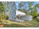 Charming light blue two-story home with a covered back porch and lush green surroundings at 5655 Captain Kidd Rd, Hollywood, SC 29449