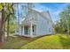 A charming home with a large covered front porch and white columns, surrounded by a lush green lawn and mature trees at 5655 Captain Kidd Rd, Hollywood, SC 29449
