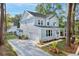 Charming two-story home features light blue siding, an attached garage, and a well-manicured front yard with mature trees at 5655 Captain Kidd Rd, Hollywood, SC 29449