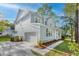 This inviting two-story home boasts a side entry garage, a covered front porch, and freshly landscaped flowerbeds at 5655 Captain Kidd Rd, Hollywood, SC 29449