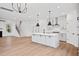 Bright, open-concept kitchen with a large island, pendant lighting, and stainless steel appliances at 5655 Captain Kidd Rd, Hollywood, SC 29449