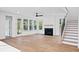 Cozy living room featuring a fireplace, abundant natural light, and access to the backyard at 5655 Captain Kidd Rd, Hollywood, SC 29449