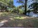 Large backyard with mature trees, sheds, and grass at 6086 Chisolm Rd, Johns Island, SC 29455