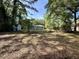 Lush backyard with mature trees, grass, and two outbuildings visible at 6086 Chisolm Rd, Johns Island, SC 29455