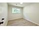 Bedroom boasts natural light with hardwood floors, neutral walls, and modern touches at 6086 Chisolm Rd, Johns Island, SC 29455