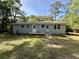 Exterior view of home with a painted brick facade and a small deck at 6086 Chisolm Rd, Johns Island, SC 29455