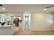 Hallway with new flooring, plenty of natural light, leading to a bright kitchen with a quartz countertop island at 6086 Chisolm Rd, Johns Island, SC 29455