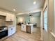 Open floor plan showcasing the kitchen, island, and living area with natural light at 6086 Chisolm Rd, Johns Island, SC 29455