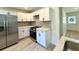 White kitchen cabinets and stainless steel refrigerator at 6086 Chisolm Rd, Johns Island, SC 29455