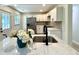 Bright kitchen features new stainless steel appliances, white cabinets, and a stylish island with quartz countertops at 6086 Chisolm Rd, Johns Island, SC 29455