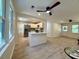 Open floor plan with a view of the kitchen island and stainless steel refrigerator at 6086 Chisolm Rd, Johns Island, SC 29455