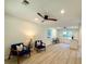 Bright and airy living room with wood-look flooring and modern ceiling fan at 6086 Chisolm Rd, Johns Island, SC 29455