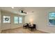Bright and airy living room with wood-look flooring and modern ceiling fan and lots of natural light at 6086 Chisolm Rd, Johns Island, SC 29455