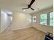 Well-lit living room featuring light wood floors, a ceiling fan, and a glass-paneled back door at 6086 Chisolm Rd, Johns Island, SC 29455