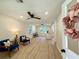 Bright and airy living room with wood-look flooring and modern ceiling fan at 6086 Chisolm Rd, Johns Island, SC 29455